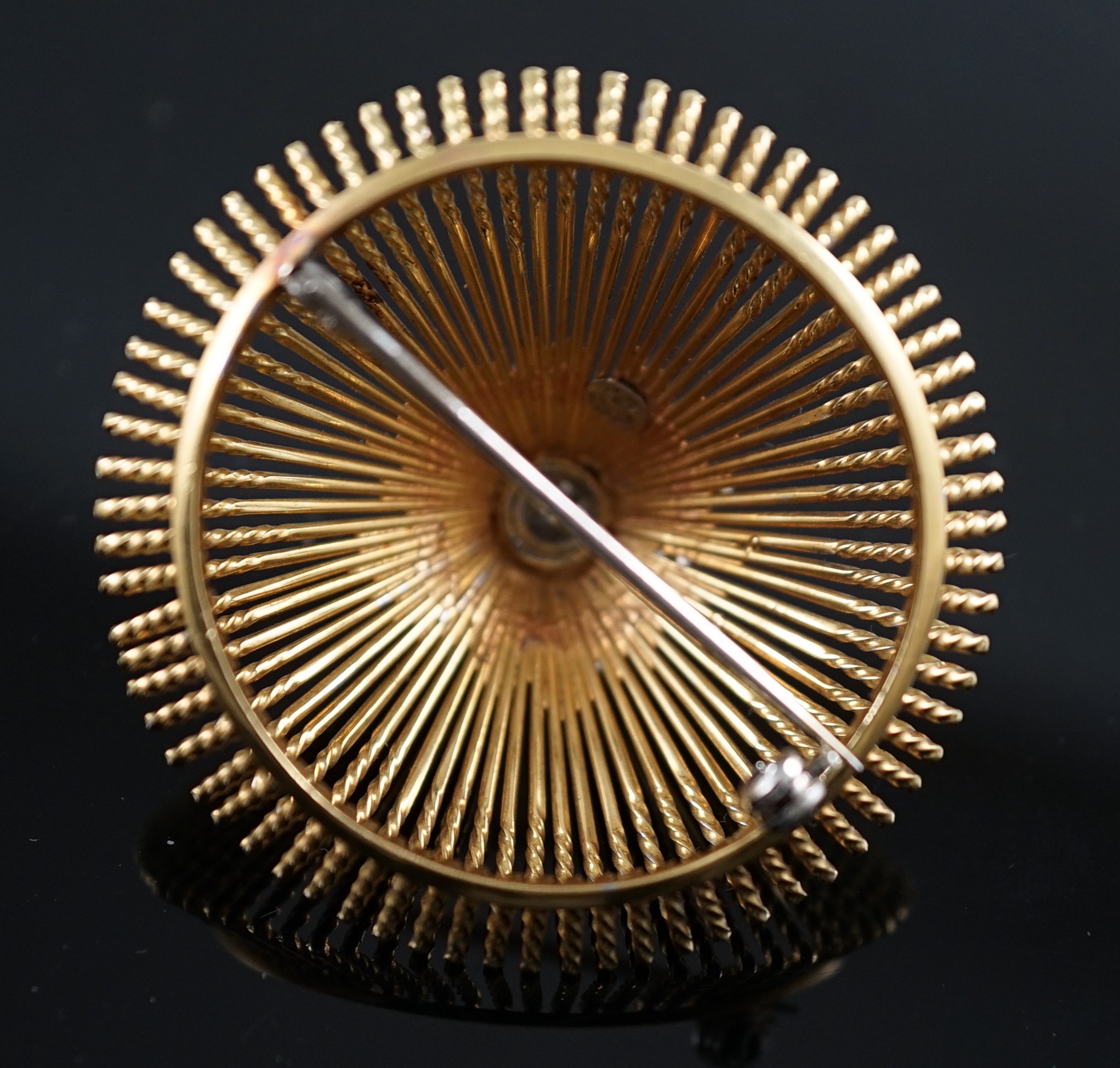 A modern stylish Italian pierced 18k and diamond chip set domed brooch